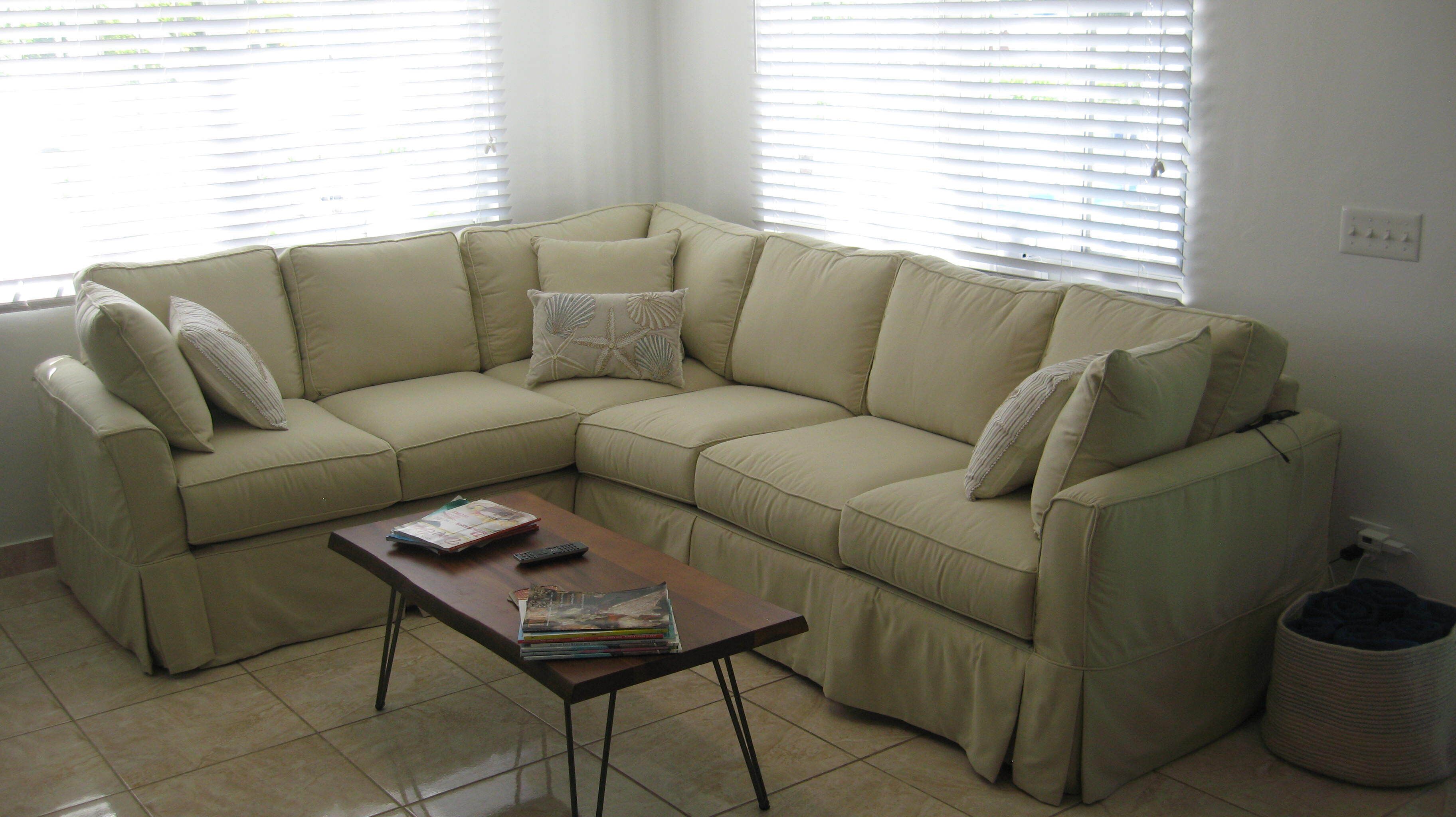 A living room with a beige corner sofa and a coffee table.