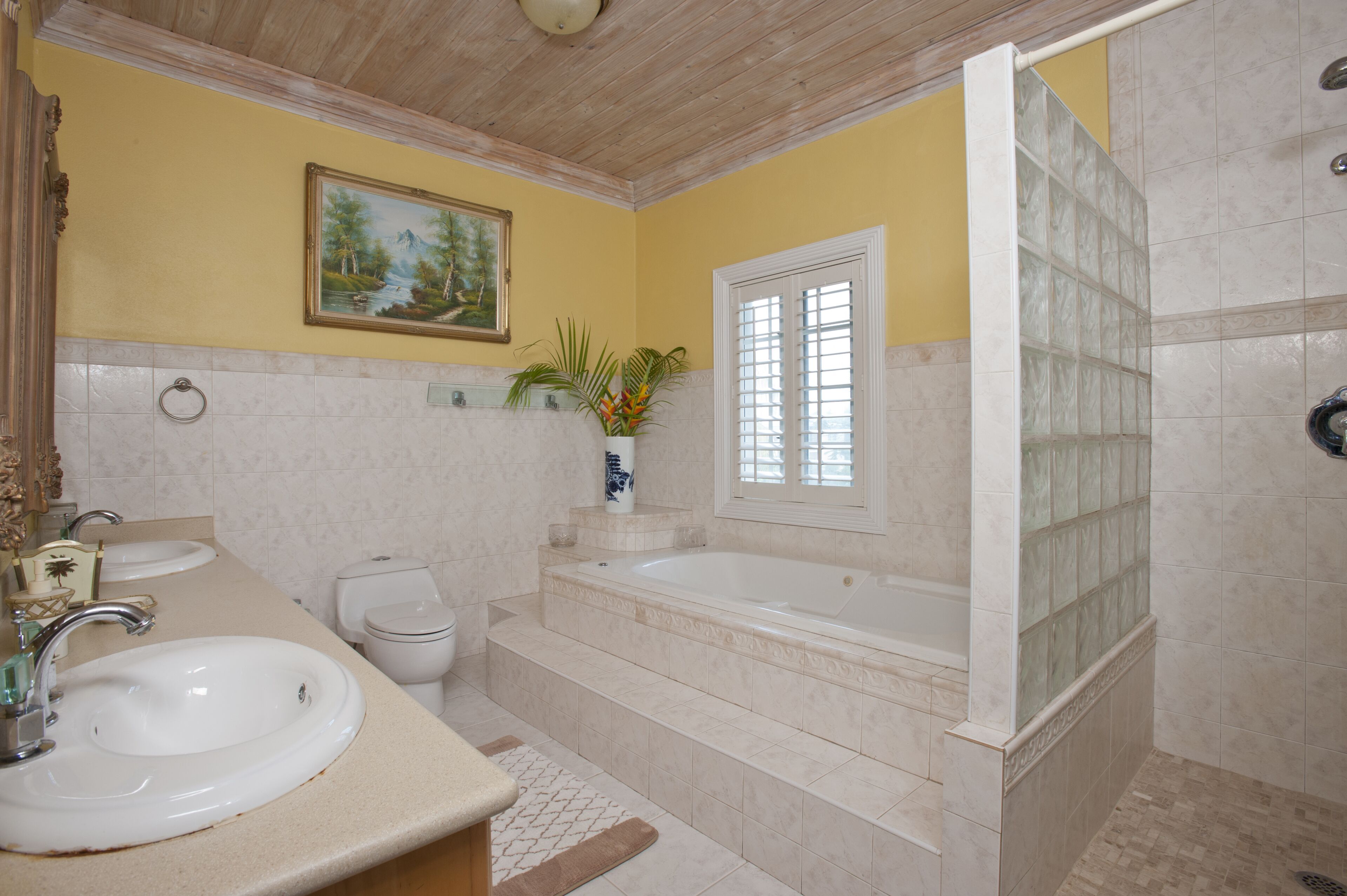 A bathroom with a bathtub, a shower, and two sinks.