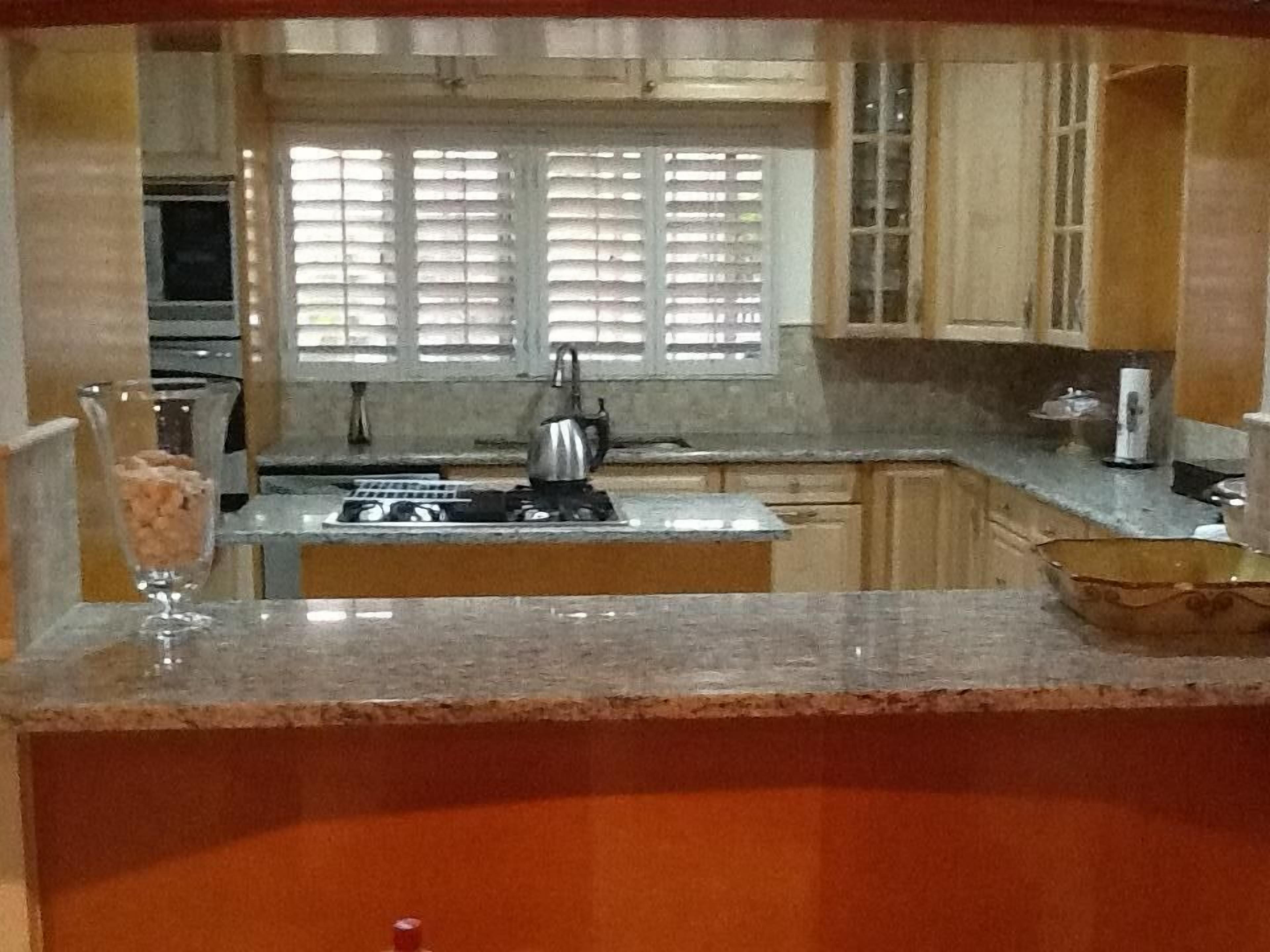 The kitchen with a gas cooktop and granite counters.
