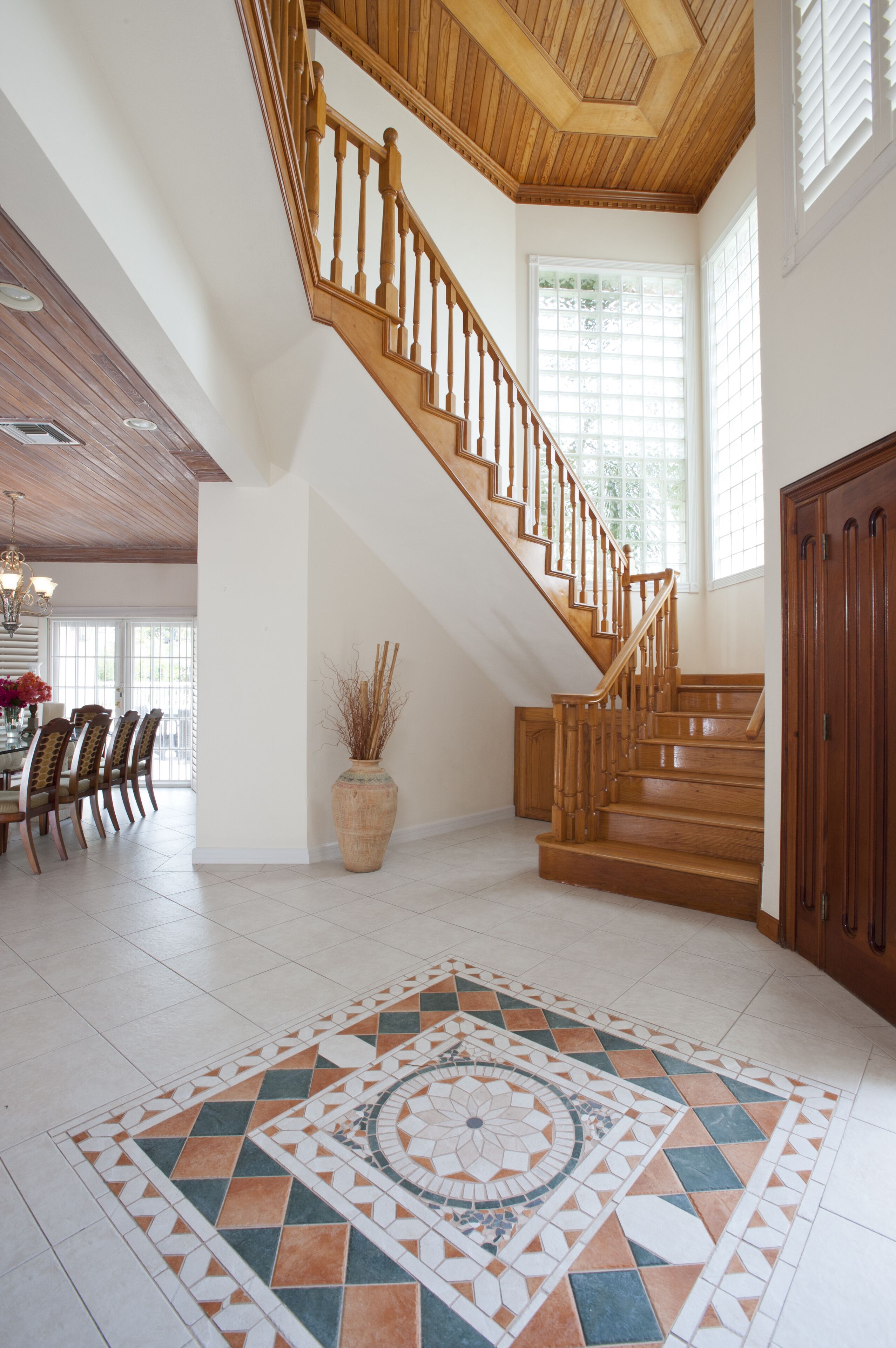 The entrance hall with a wooden staircase.