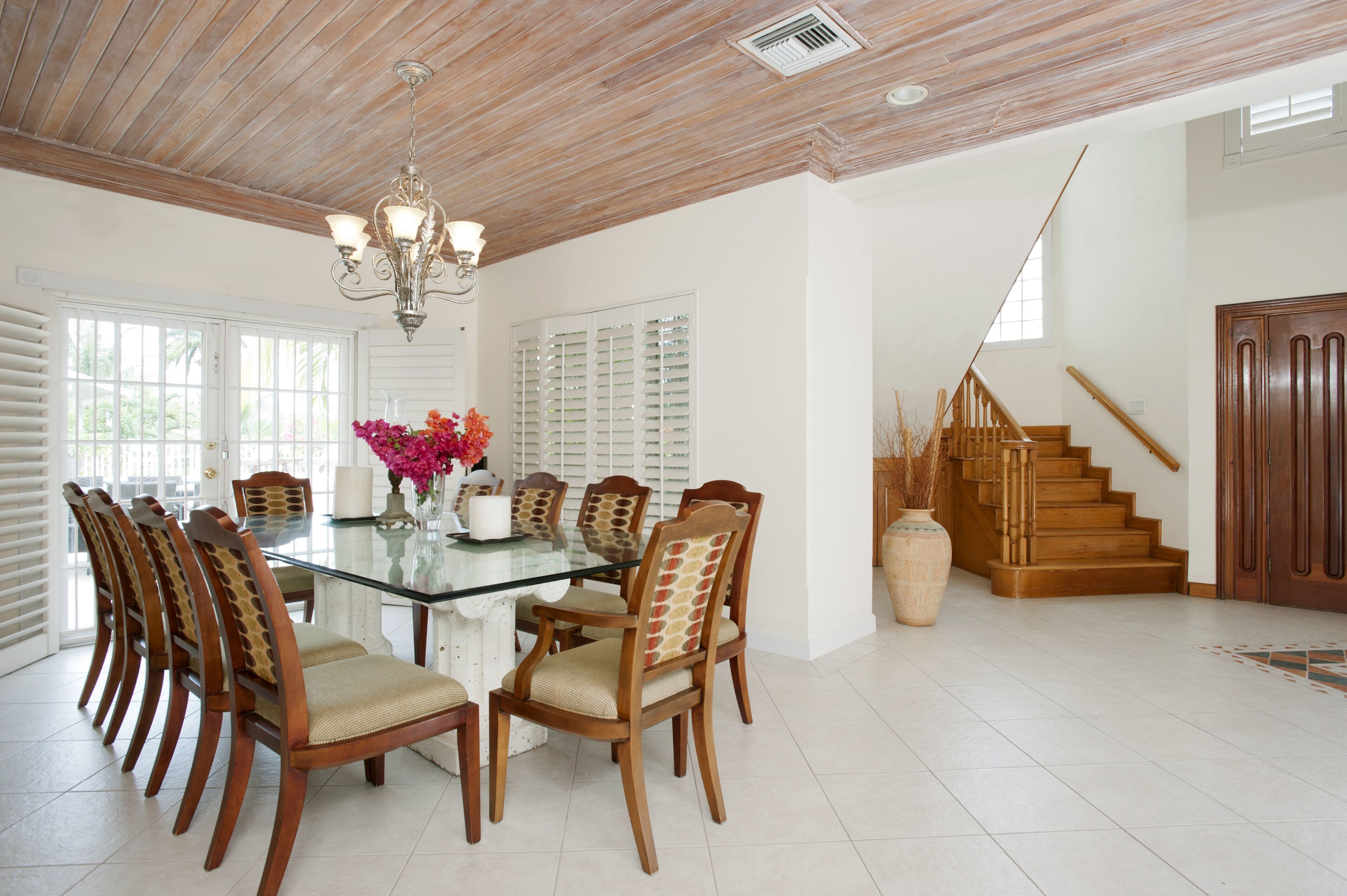 The dining room with a glass table and chairs.