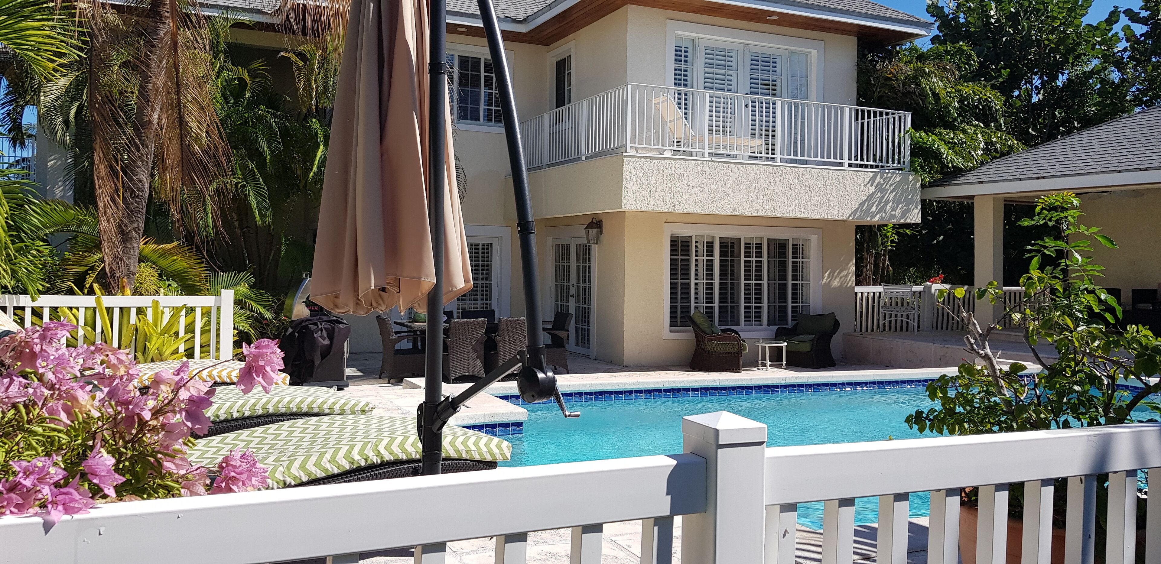 The pool and the back of the house in daylight.