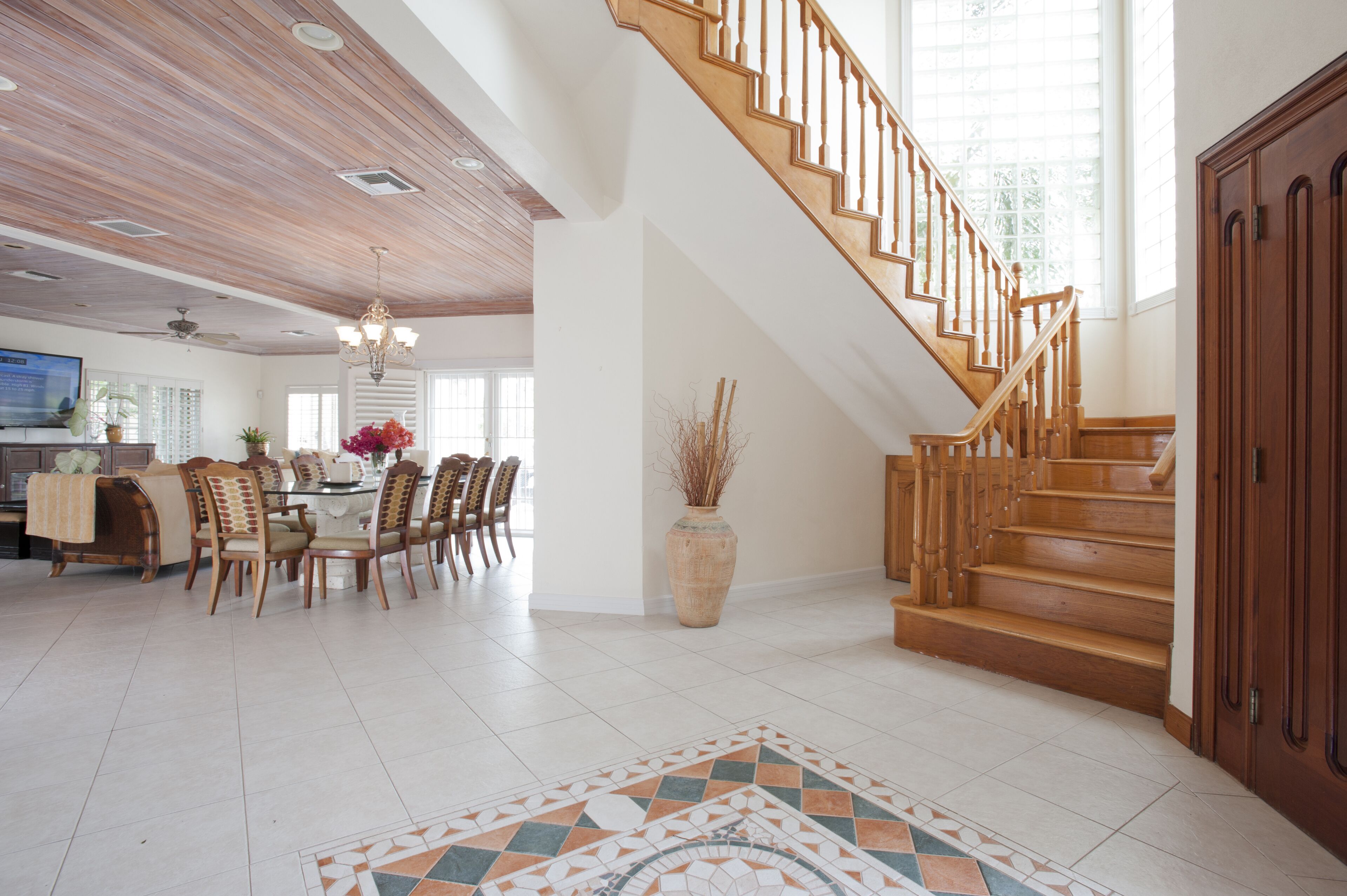 The entrance hall with a staircase and the dining area.