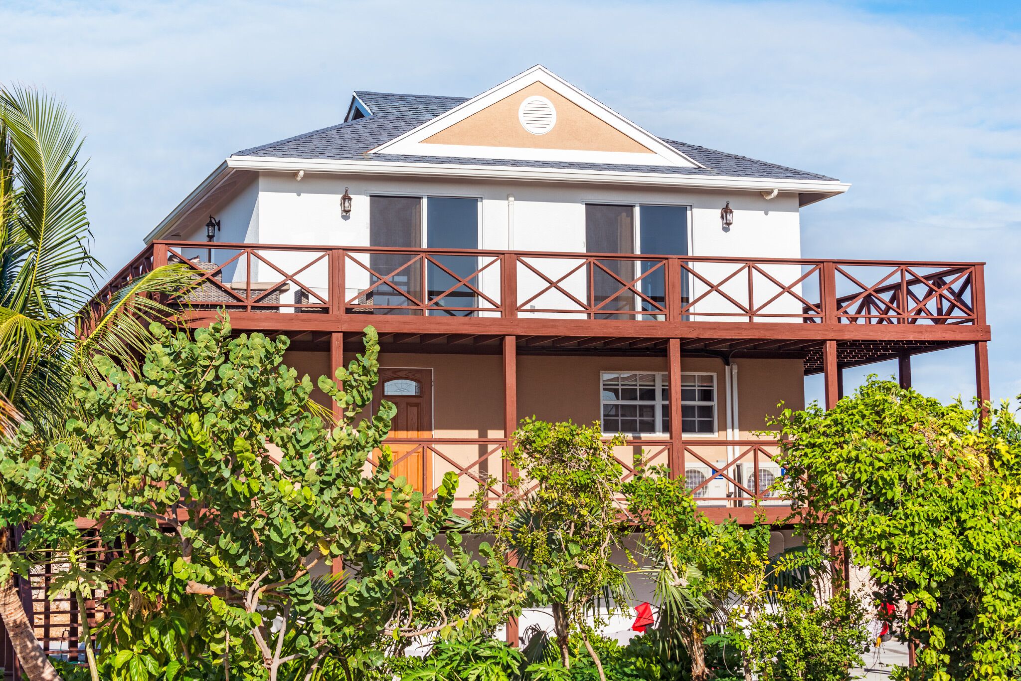 The villa with wood balconies.