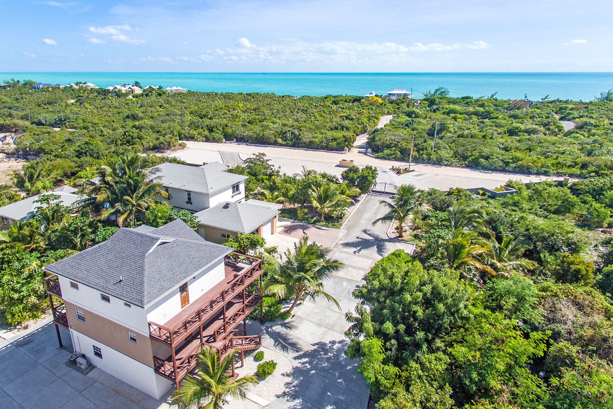 The villa, the drive, and the sea from above.