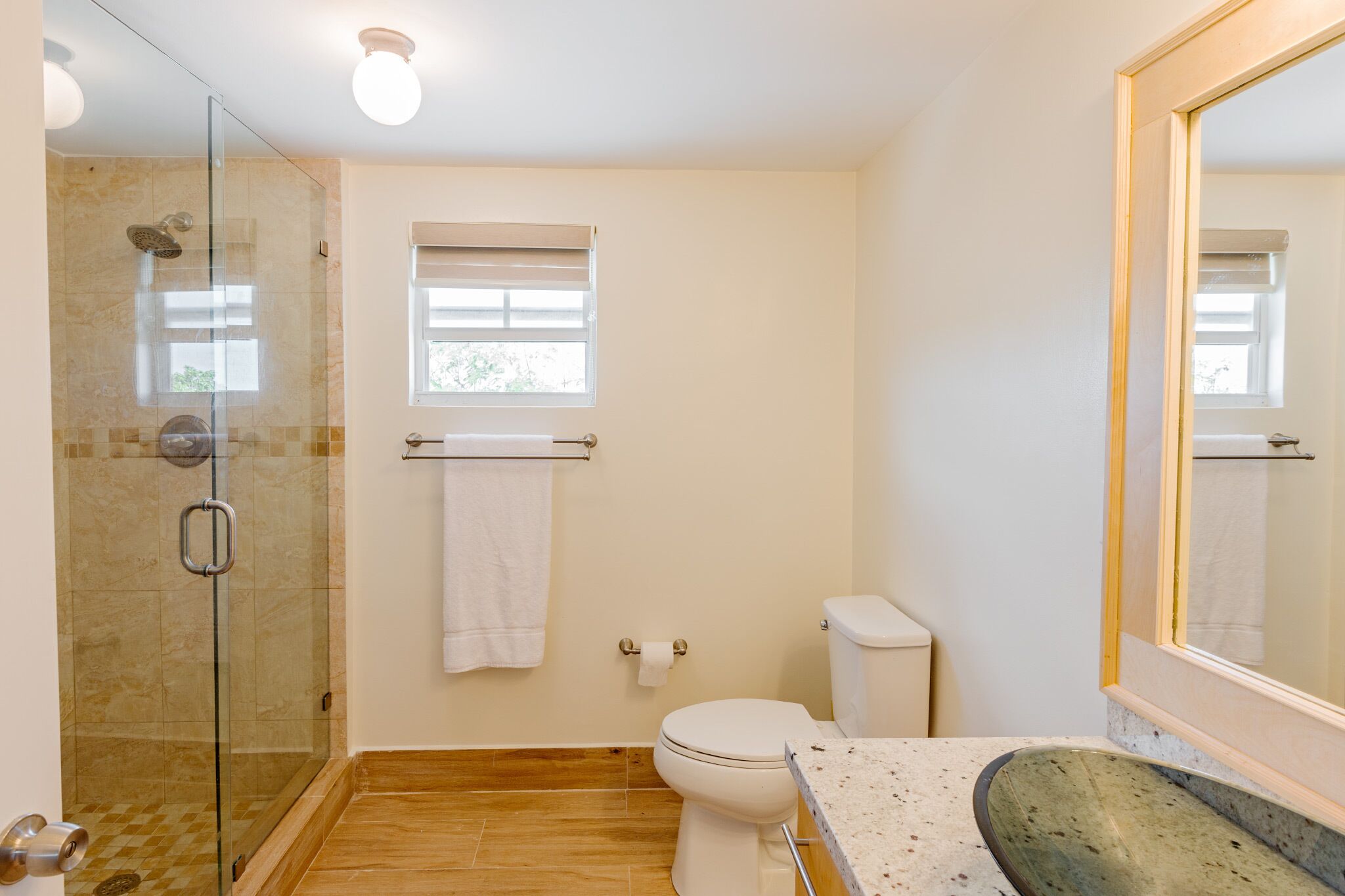 A bathroom with a shower and a toilet.