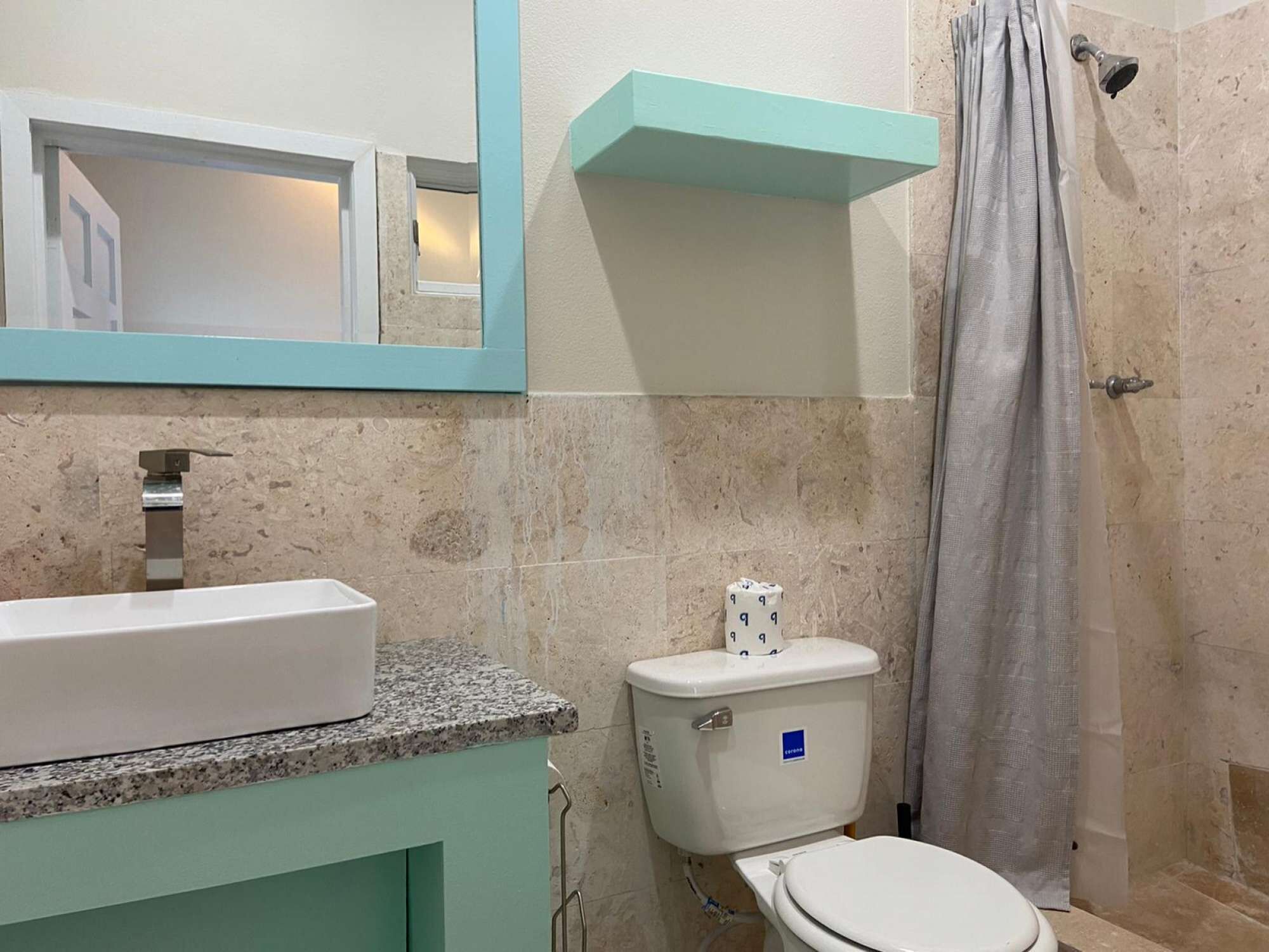 A bathroom with a sink, a toilet, and a shower.