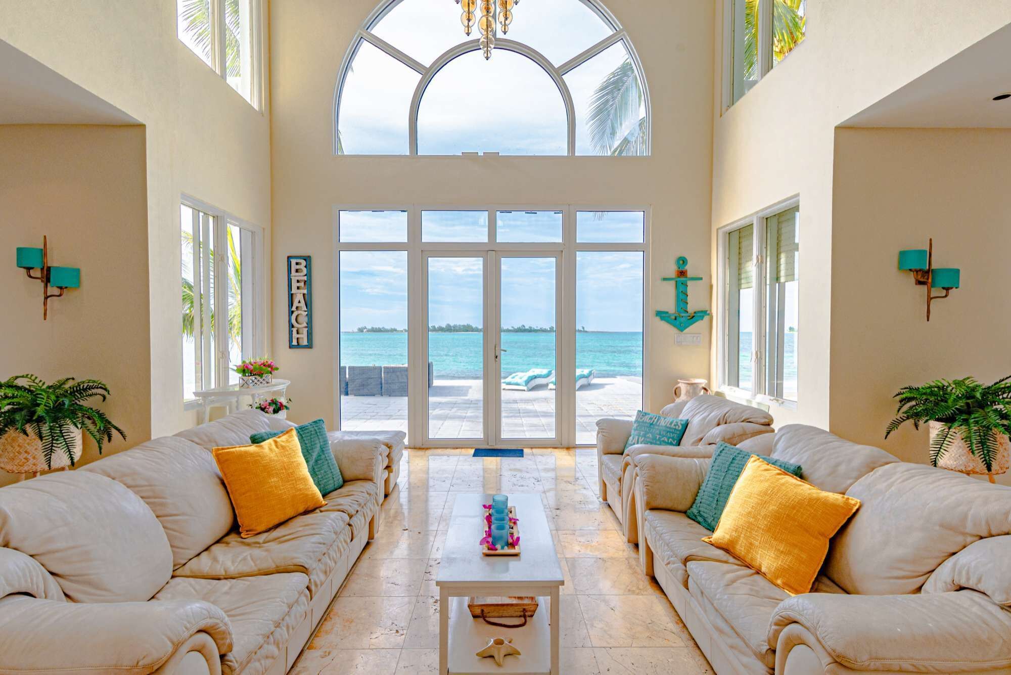 The living room with glass doors to the sea.