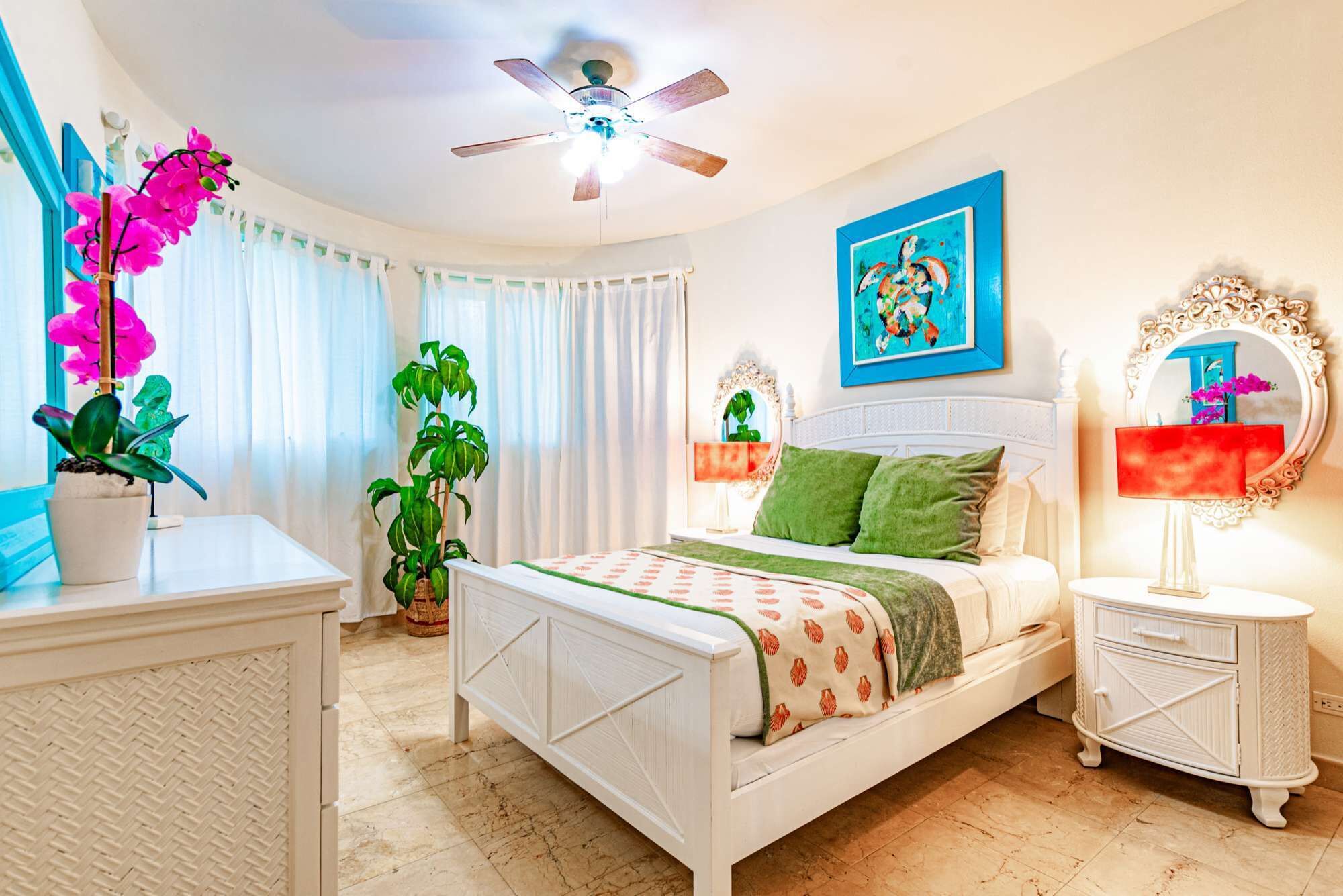 A bedroom with a bed and a turtle painting.