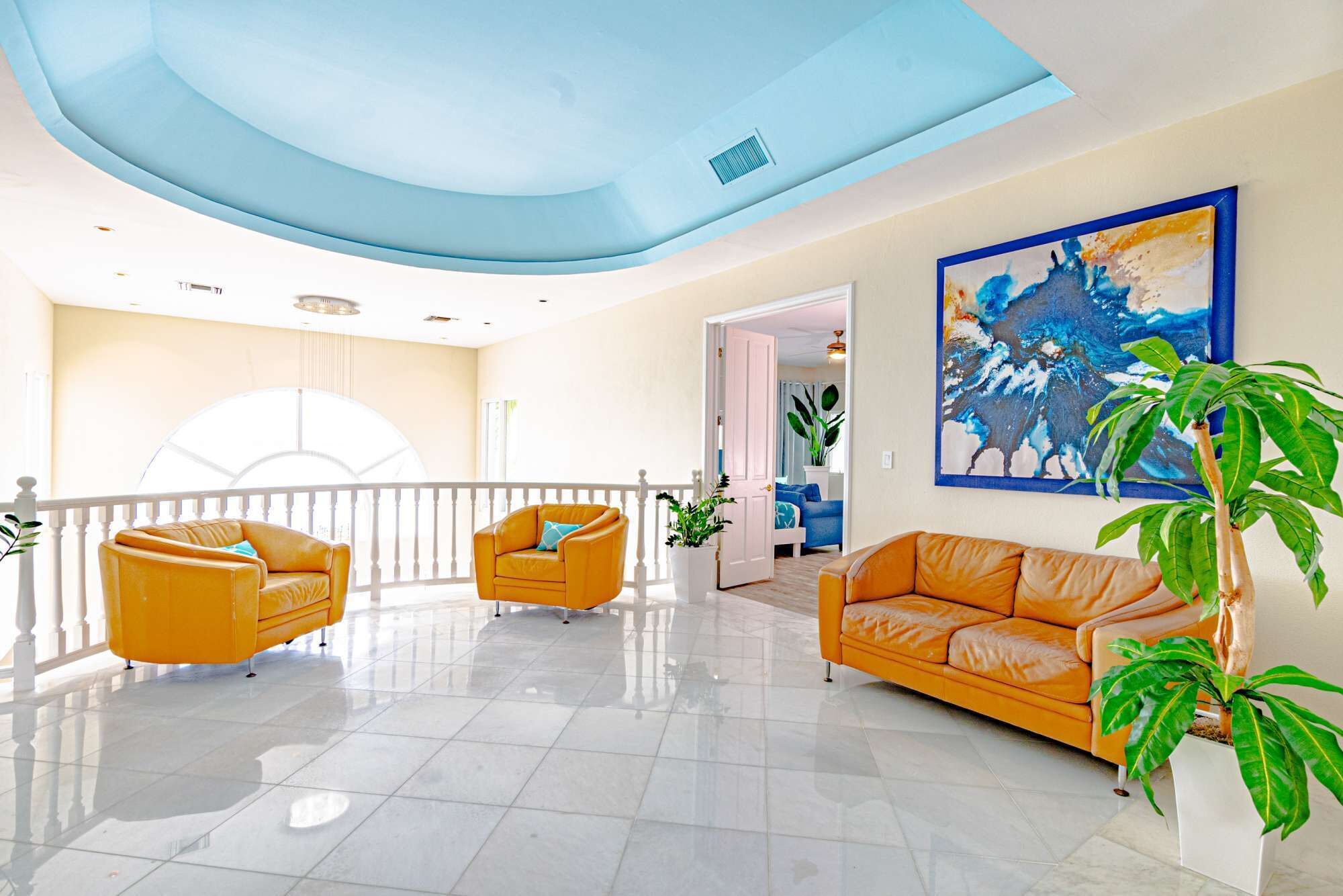 The upper landing with orange sofas.