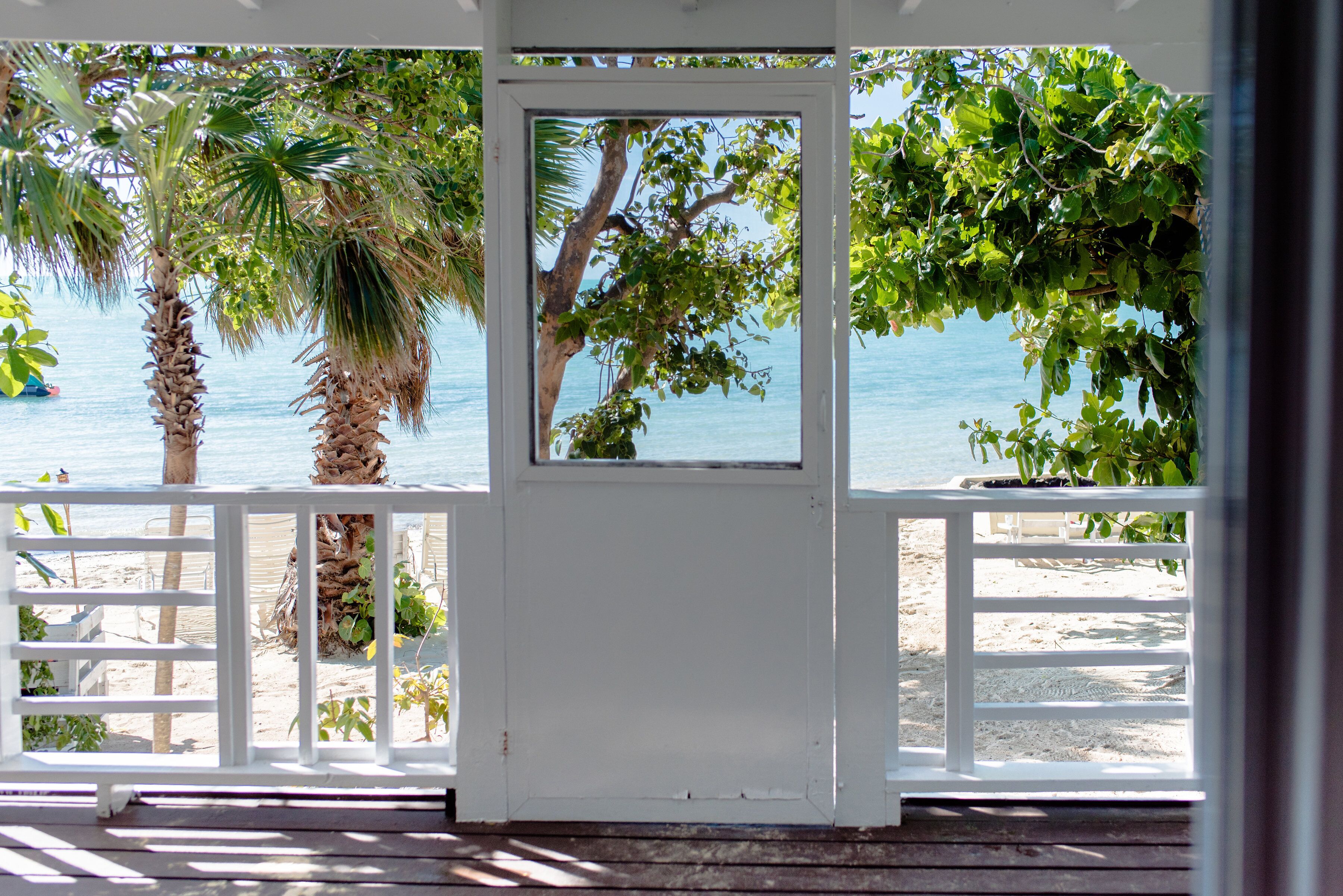 A view of the beach and the sea from the screened porch.