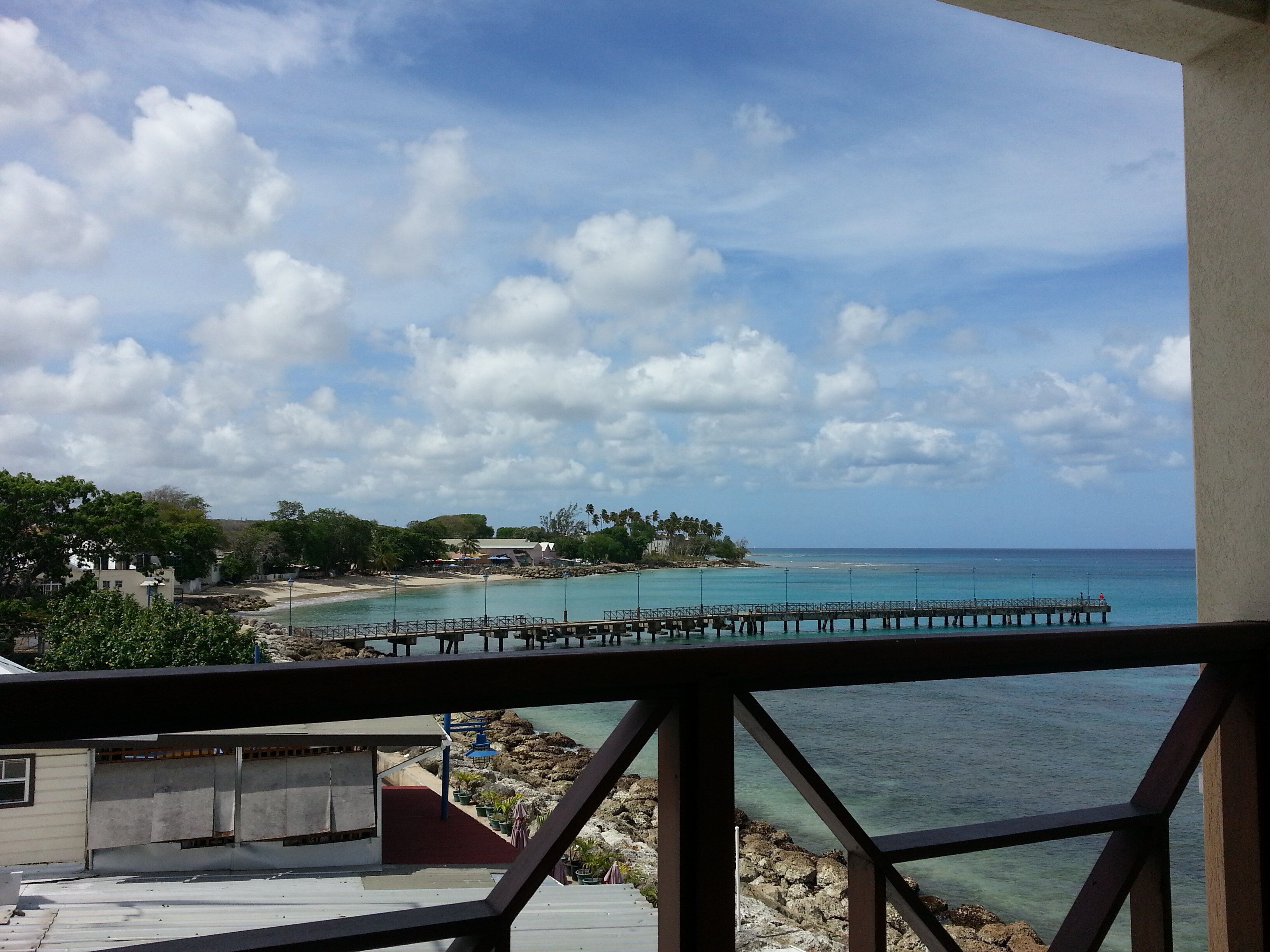 A view of the beach, the pier, and the bay from the balcony.