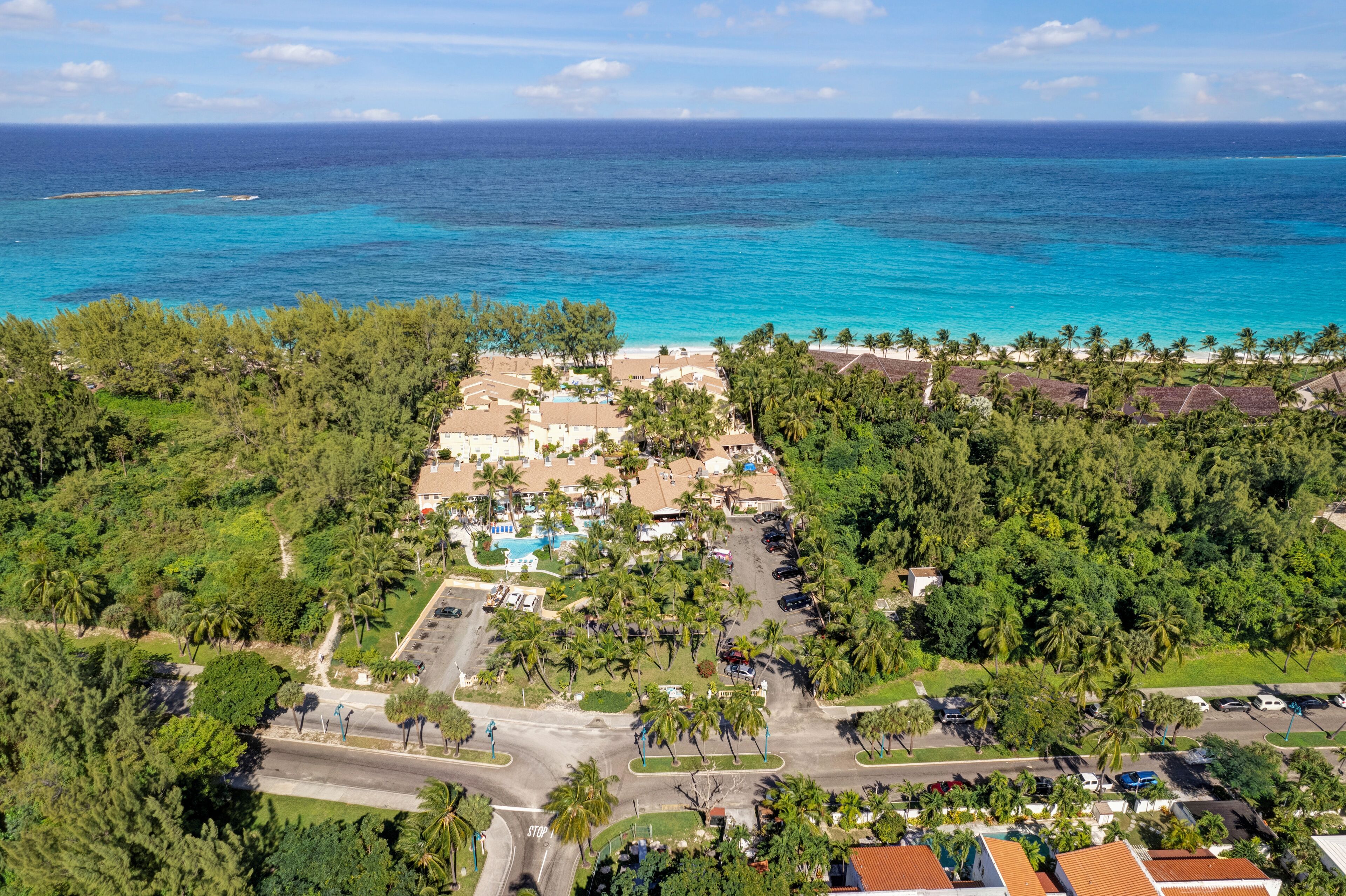 An aerial view of the beachfront villas and the turquoise sea.
