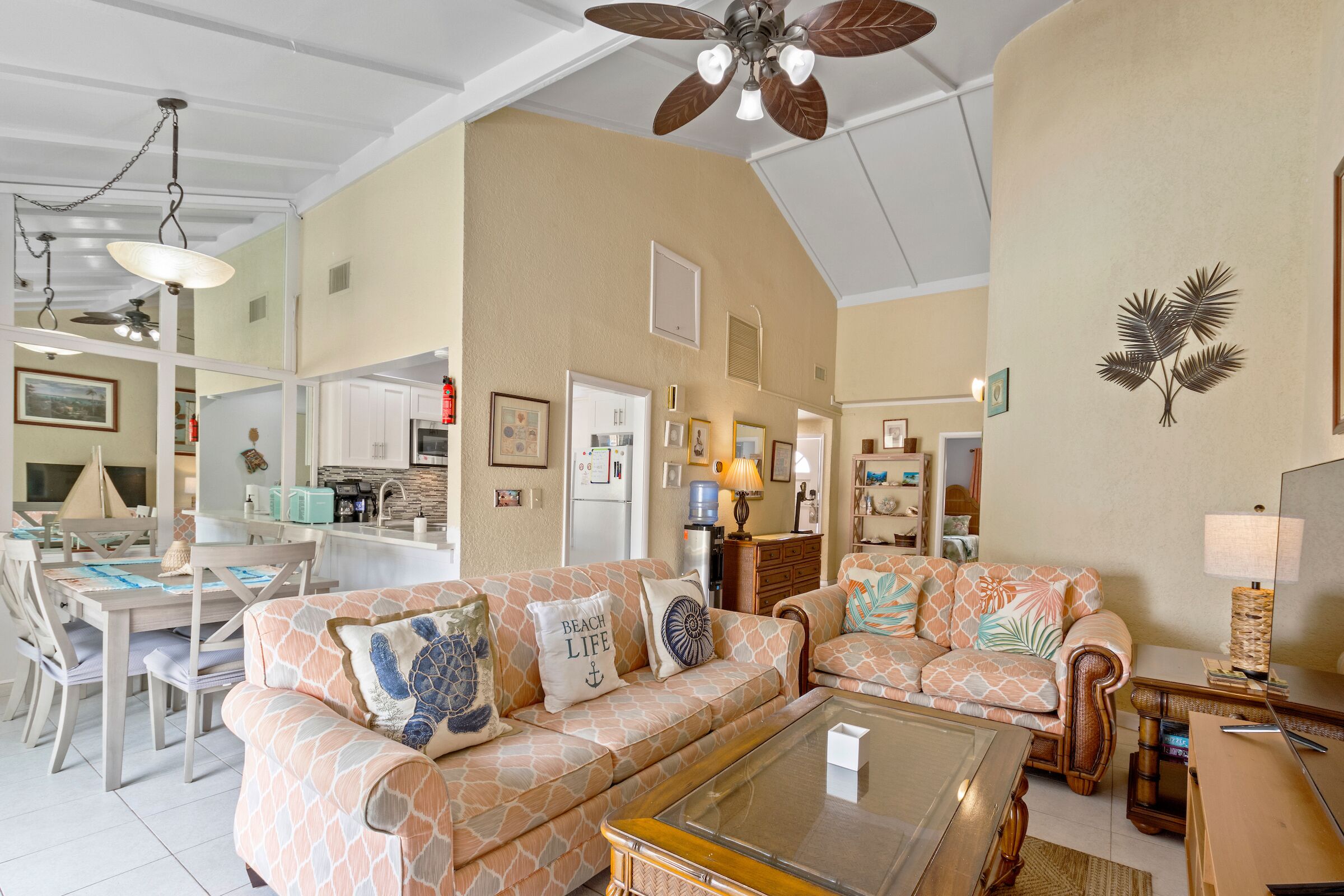 The living room and the dining area under a ceiling fan.