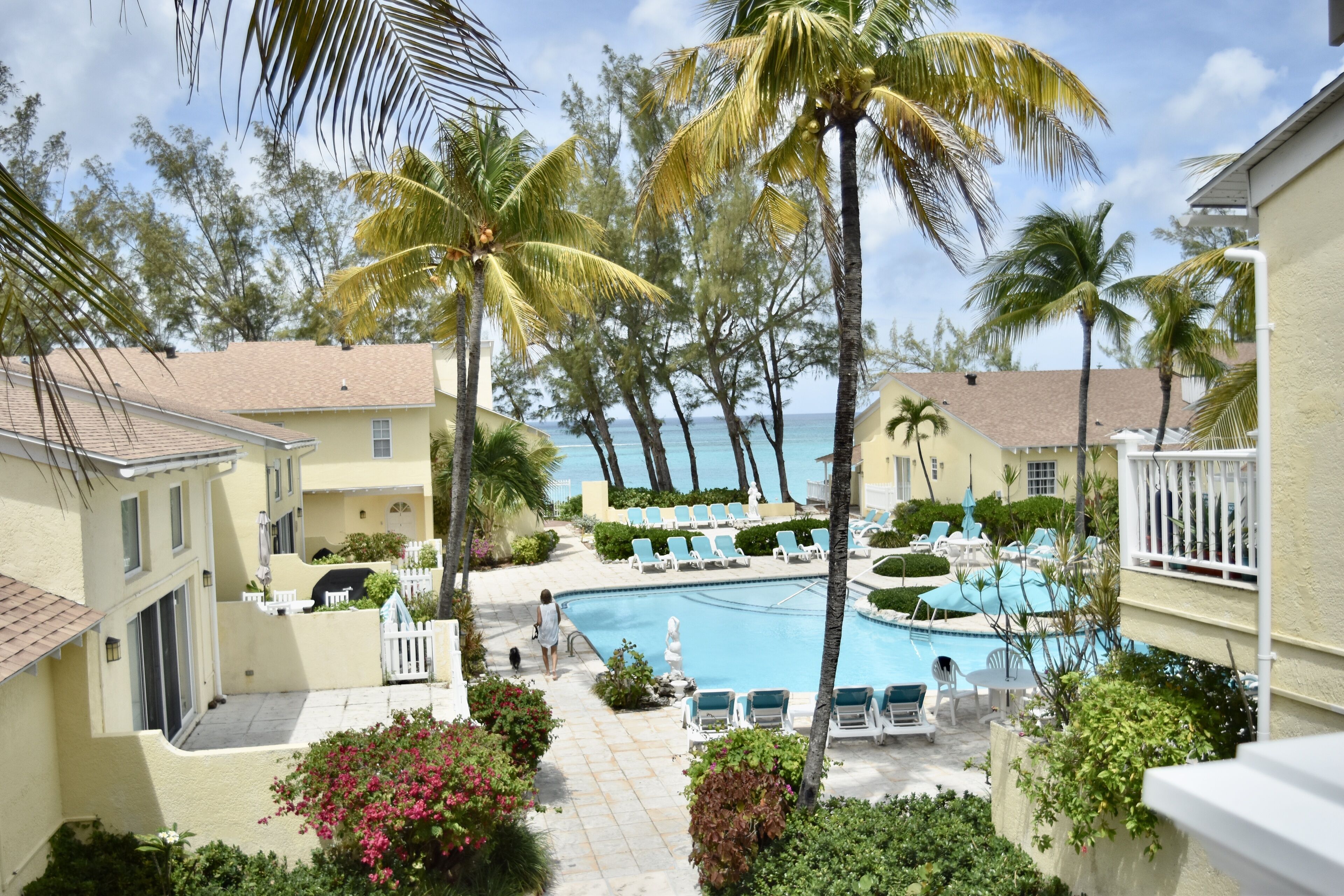 A view of the shared pool, the villas, and the sea.