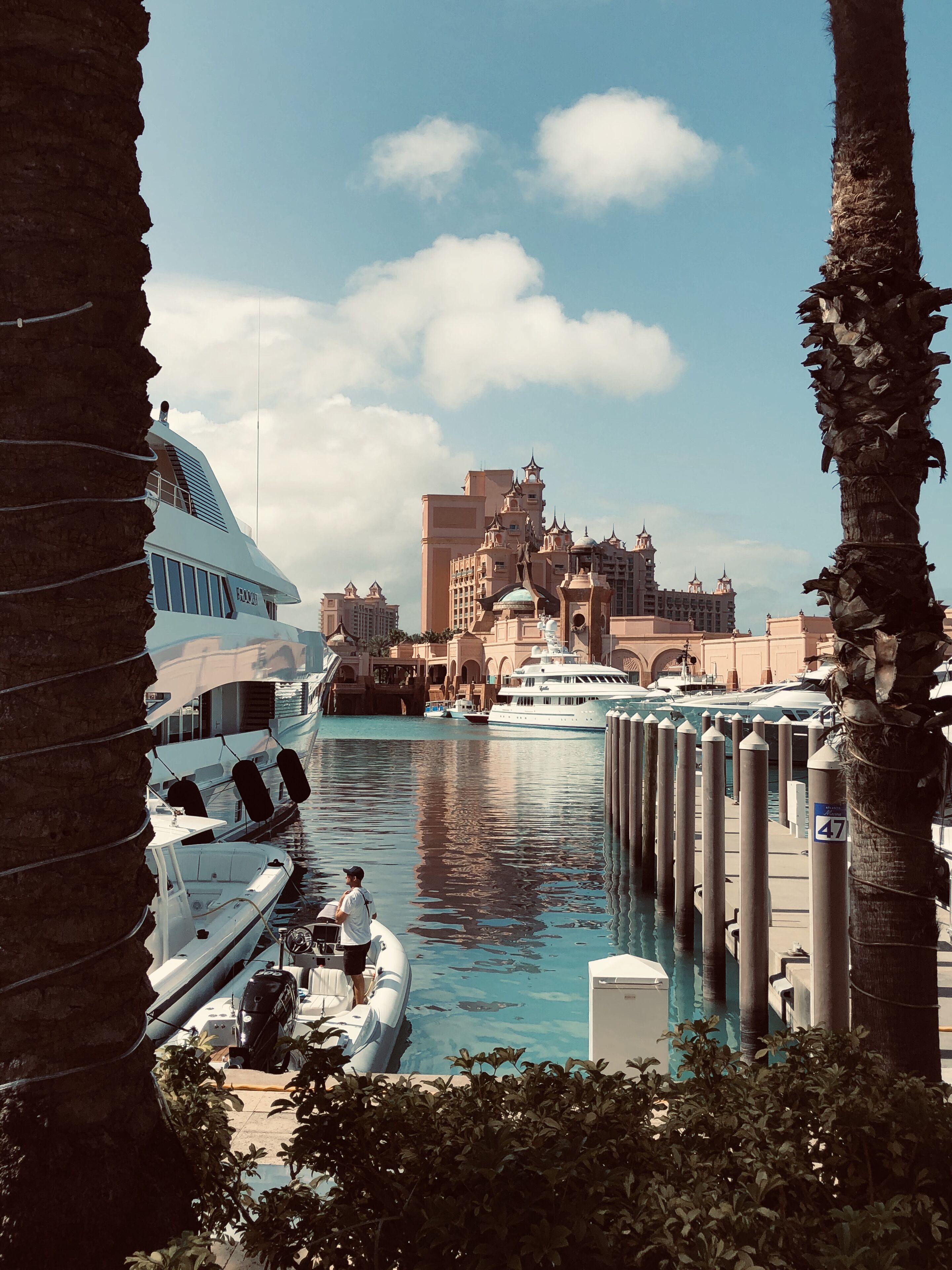 A marina with yachts and the Atlantis resort in the background.