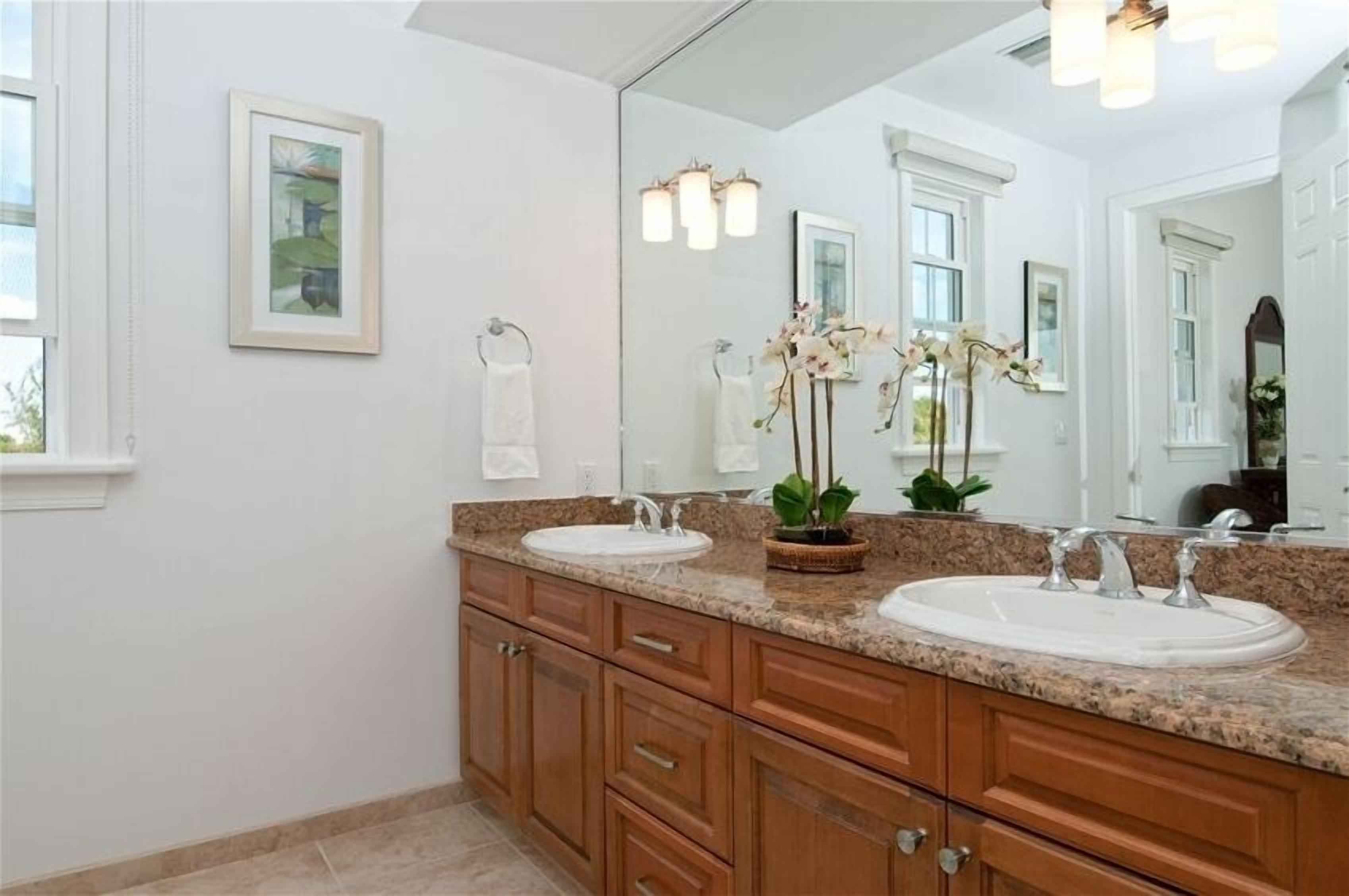 A bathroom with two washbasins and a large mirror.