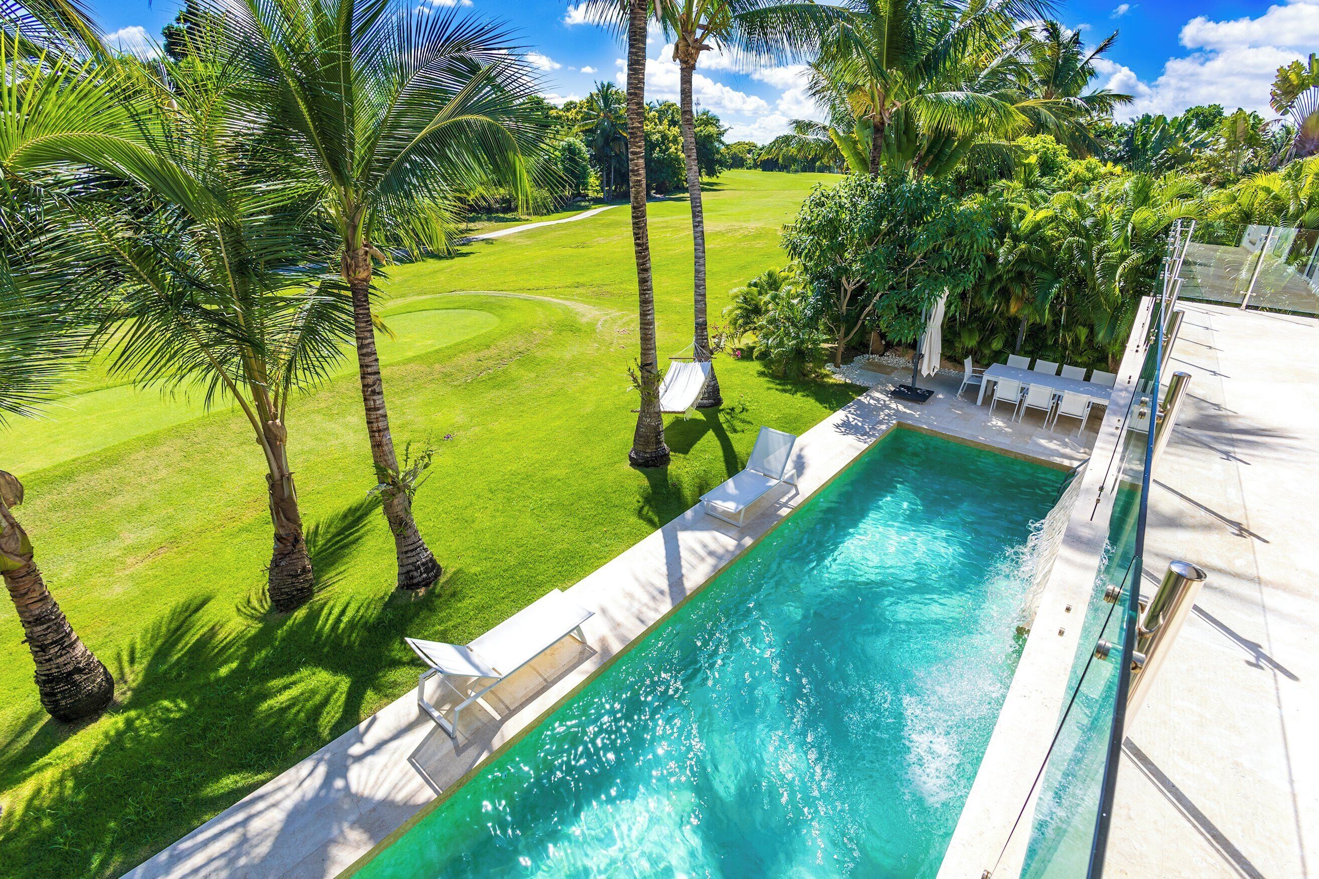 The view from above shows the pool, the terrace, a hammock, and the golf course.