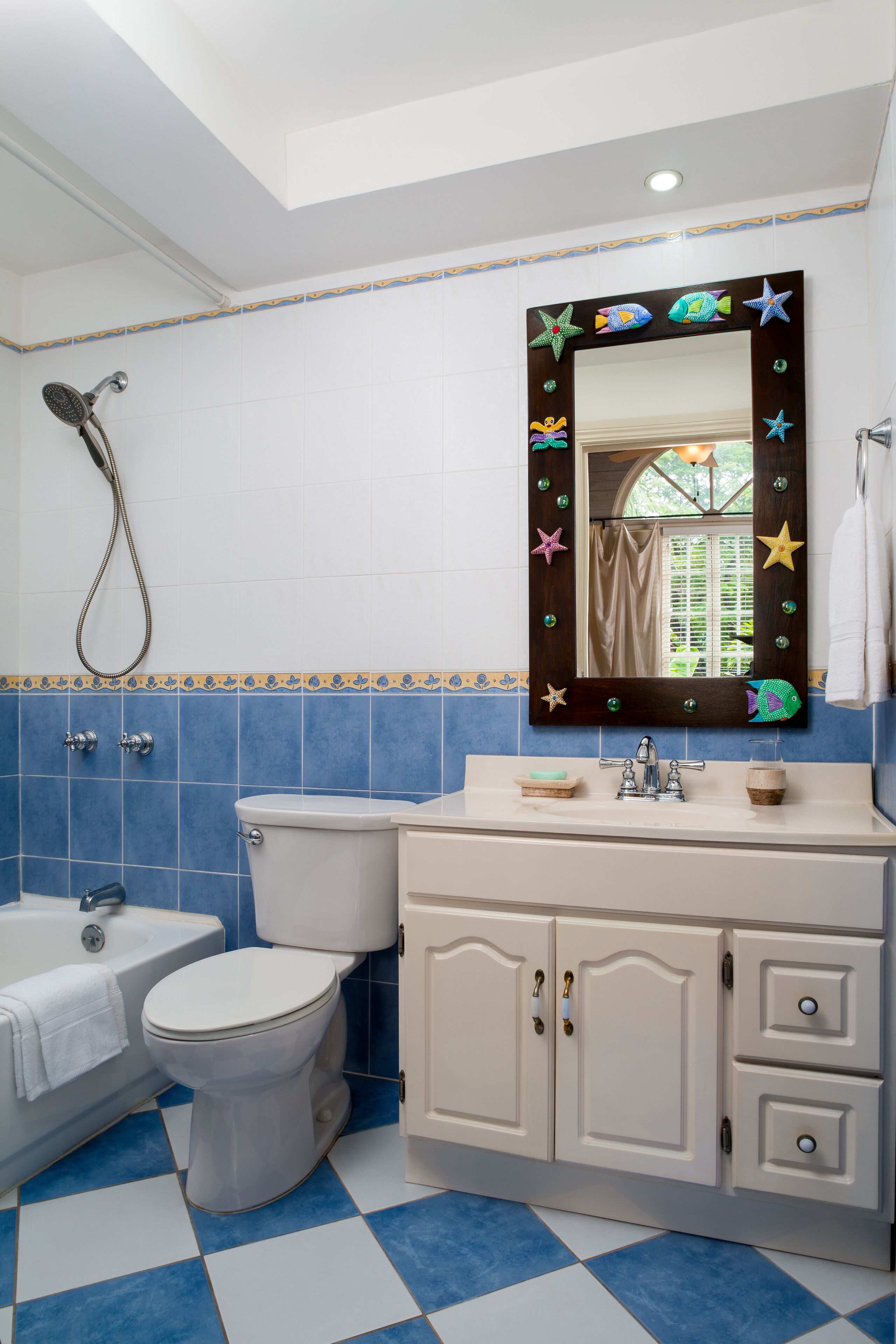 A bathroom with a bathtub, a toilet, and a vanity.