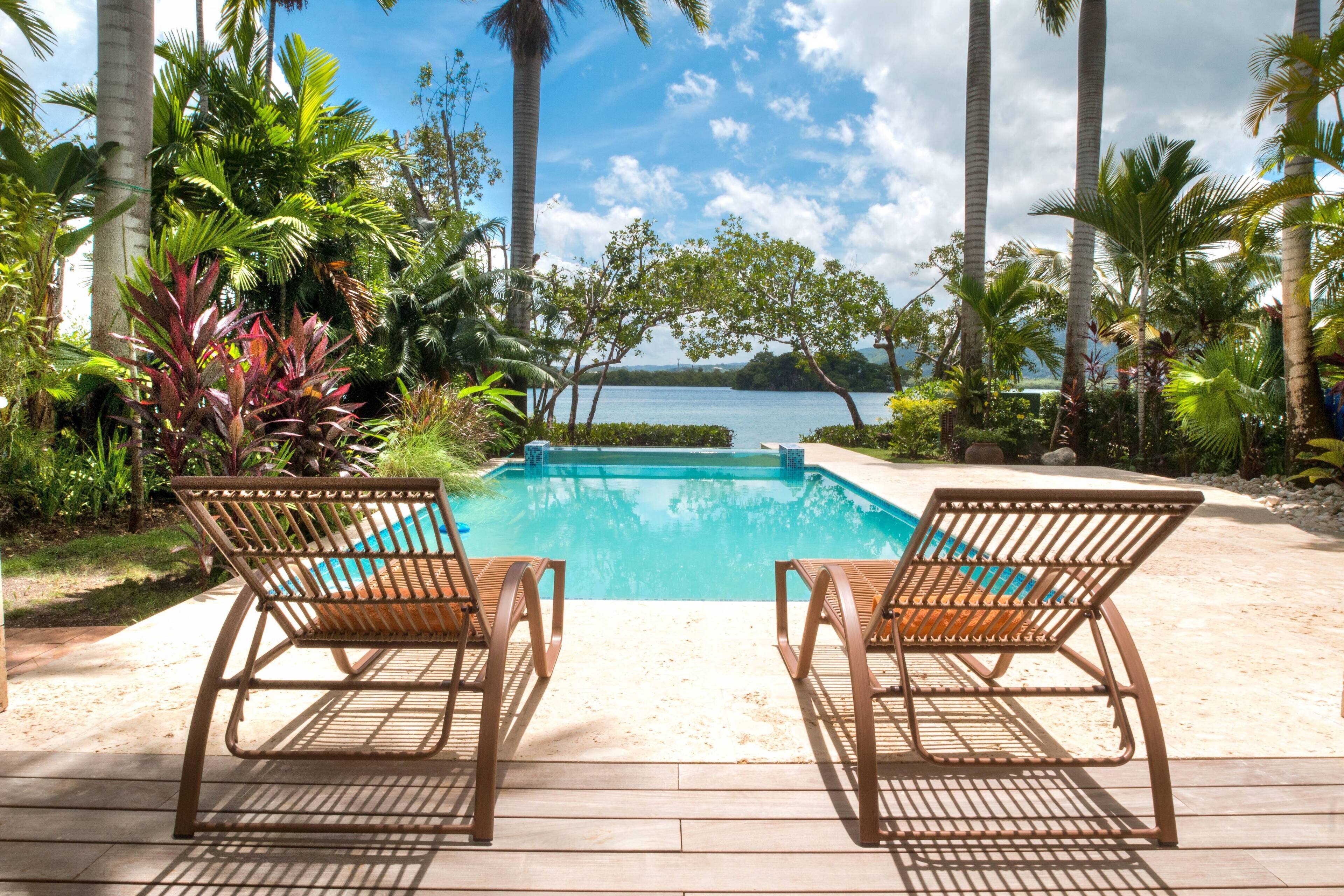 Two sun loungers face the pool and the bay.